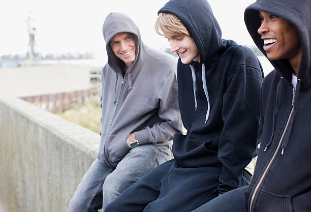 three-young-men-in-hoodies-sitti